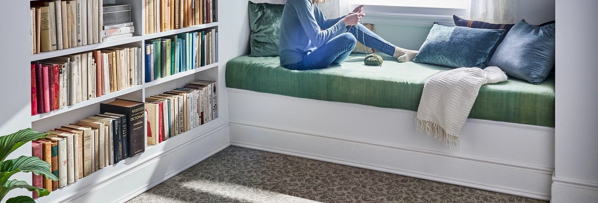 person reading in window from Anderson Tile & Carpet in Anderson, SC